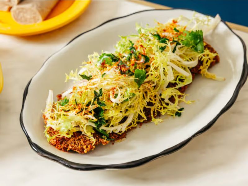 Bright frisée and herb salad dusted with berbere