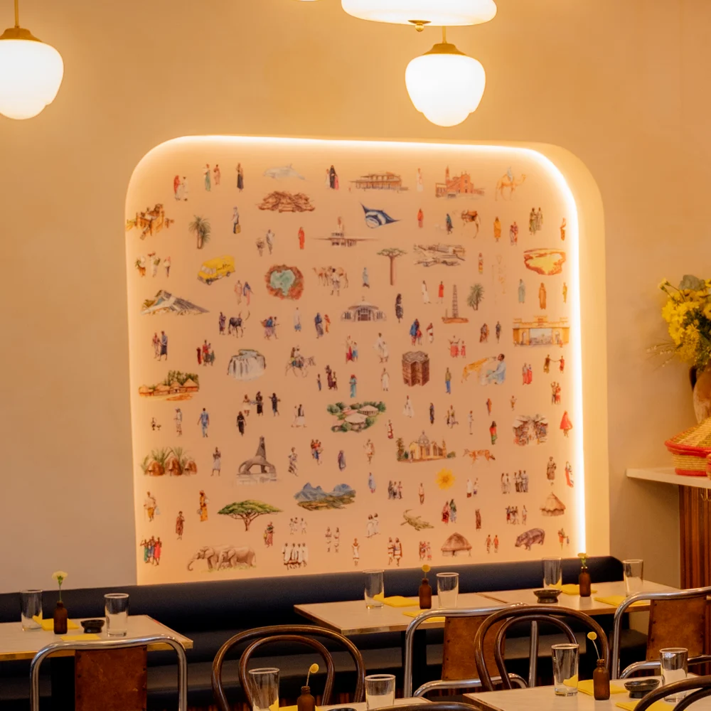 The arch at Makina: the painted mural lit in its alcove above the banquette.