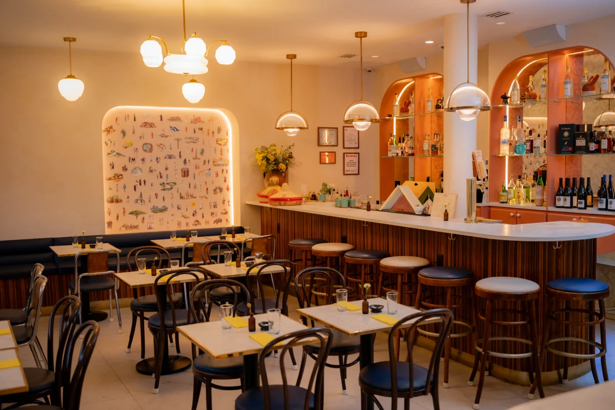 The dining room at Makina, the painted arch lit in its alcove beside the bar.